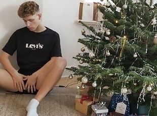 Jakob jerks his uncut cock under the Christmas tree and squirts his sperm on his body