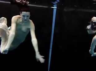 Skinny teens swim in the deep pool naked