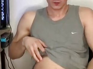 Boy jerks his big cock and cums on t-shirt