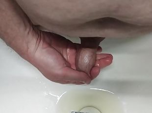 Pissing into the sink and into the foreskin