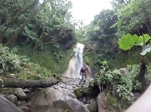 Guy walks trail to waterfall