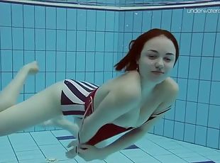 Elegant lada takes off a swimsuit to show her nude body underwater