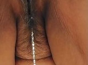 Mature Latina granny pissing pee with graying hairy pussy and big clit