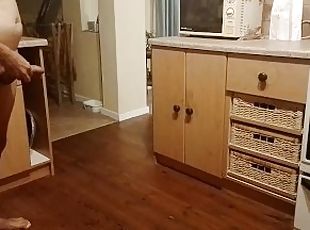 Sexy guy pissing all over the kitchen floor and making a big puddle