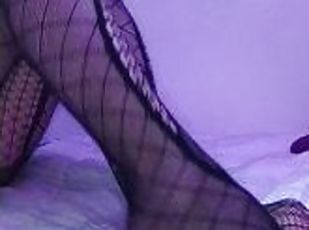 I crush a dildo with my feet in fishnet stockings