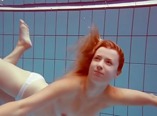 In The Indoor Pool, A Stunning Girl Swims